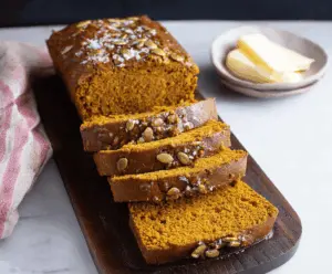 Delicious homemade Copycat Starbucks Pumpkin Bread topped with walnuts and cinnamon, ready to enjoy.