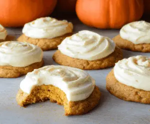 Delicious Pumpkin Cream Cheese Frosted Cookies topped with creamy frosting and festive pumpkin decorations for fall baking