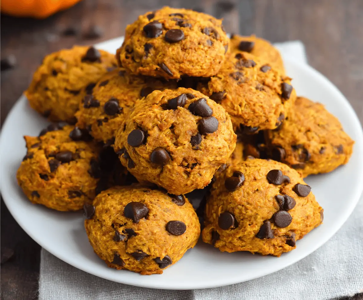 Delicious and healthy homemade pumpkin cookies with cinnamon and oats on a rustic plate, perfect for fall treats.